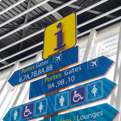 Airport info signs for passengers about gates and lounges