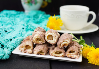 Cookies rolls with rhubarb and cinnamon on a dark background