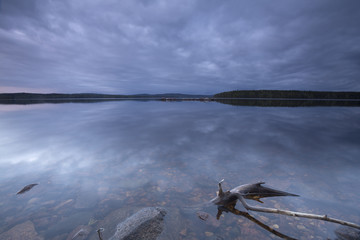 Calm lake at twilight, wood in the foreground, dalarna, sweden