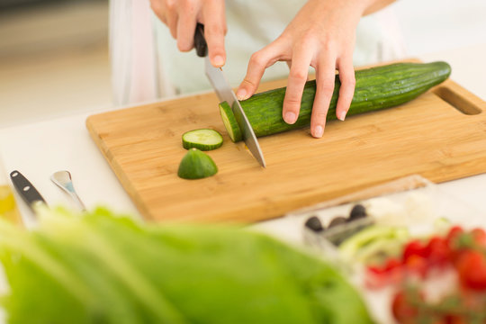 woman chopping cucumber