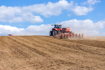 Tractor harrowing the field
