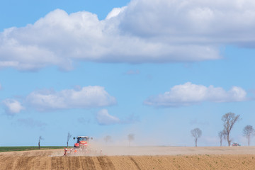Tractor harrowing the field