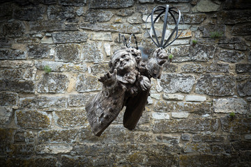 wooden angel statue on stone wall