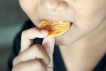 The boy is eating a delicious biscuits. © seagames50