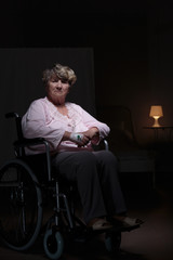 Fototapeta premium Lonely woman sitting on wheelchair