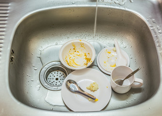 Kitchen conceptual image. Dirty sink with many dirty dishes.