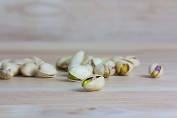 Close up pistachios on wooden background