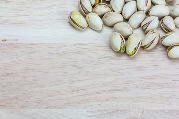 Close up pistachios on wooden background,Copy space