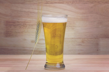 Glass beer and bale on wood background