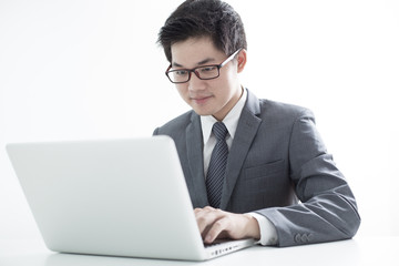 Handsome businessman working with laptop