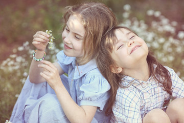 Fototapeta premium Young girls have fun under the shade of a summer day