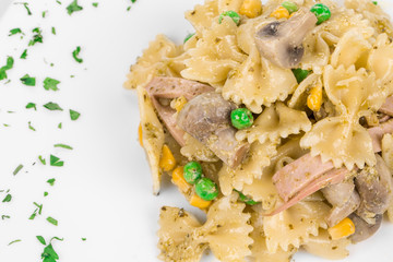 Pasta farfalle with ham and mushrooms 