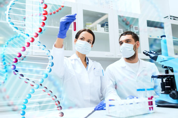 scientists with test tubes making research in lab