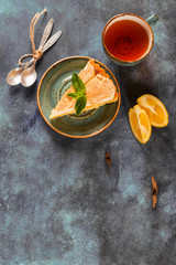 Piece of fresh homemade lemon meringue tart on wooden table