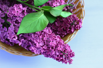 lilac in a basket on a wooden background