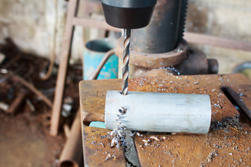 Metal drilling closeup in metal workshop