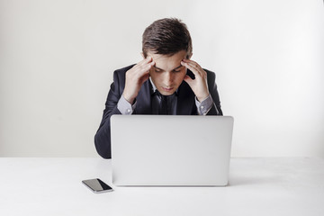 Close up image of multitasking business man using a laptop and m
