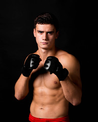 Fototapeta na wymiar Portrait of boxer hitting in gloves.