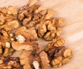 Close up of walnut kernels on wood table.