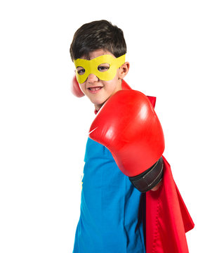 Child dressed like superhero with boxing gloves