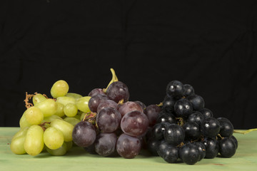Grape fruit on green table with black background