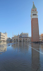 Fototapeta na wymiar Campanile of Saint Mark in Venice with the high tide