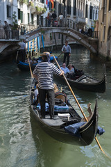 Fototapeta na wymiar Typical scene from a small canal in Venice with gondolas