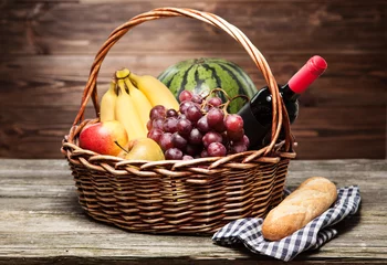 Fotobehang Basket full of fresh fruit © George Dolgikh