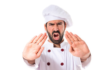 Chef making stop sign over white background