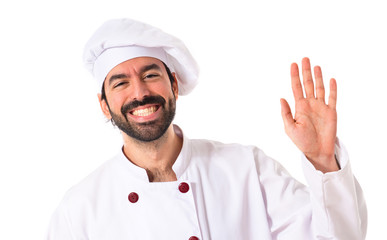 Chef saluting over white background