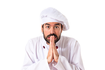 Chef pleading over white background