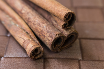 Cinnamon sticks close-up on brown background