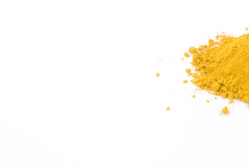 Neat pile of turmeric powder isolated on a white background with room for copy