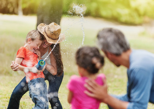 Cheerful Family Does A Water Gun Fight