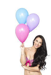 Attractive Young Smiling Brunette holding Colorful Balloons - 83643003