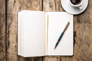 Notebook with fountain pen and cup of espresso