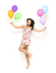 Attractive Young Smiling Brunette holding Colorful Balloons - 83643044
