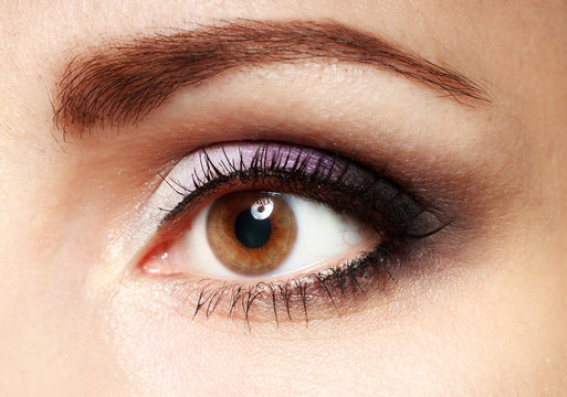 Female eye with long eyelashes close up image.