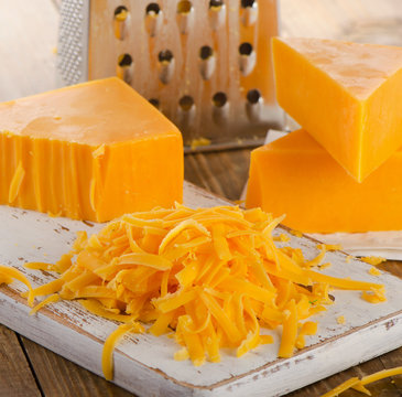 Grated Cheddar Cheese on  Cutting Board.