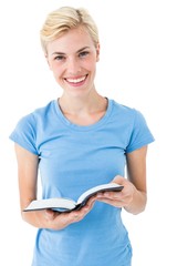 Blonde woman holding bible and looking at camera