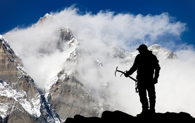 Mount Lhotse and silhouette of man wirh ice axe