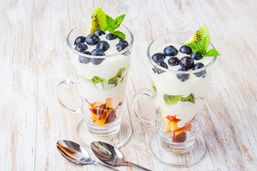 Fresh fruit in cream. Dessert from fruit and cream