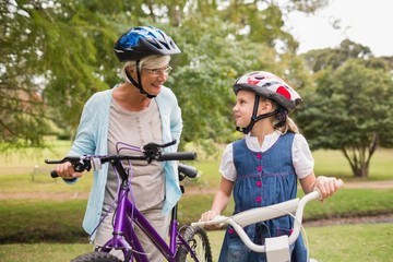 Naklejka premium Grandmother and daughter on their bike 