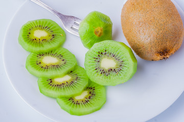 Kiwi fruit on white plate