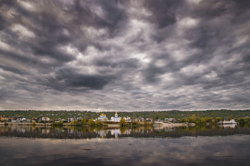 Obraz premium dark clouds river temple.