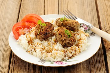 Three lentil patties with rice, tomato and microgreens in white