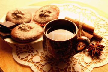 Chocolate muffins and a cup of brewed coffee.