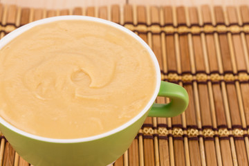 Pea soup in a green bowl.