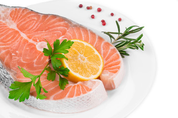 Raw salmon steak with lemon.