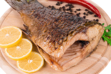 Fried carp tail with lemon and pepper.